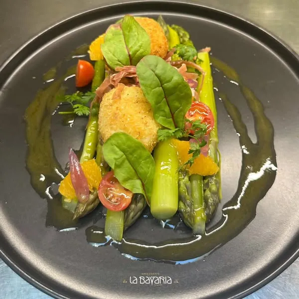 Salade d'asperges blanches fondantes, oeuf mollet coulant et copeaux de parmesan, chiffonnade de jambon cru de la Forêt Noire, vinaigrette fraîche d'agrumes